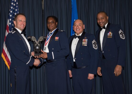Capt. Venita Ramirez accepts the 366th Fighter Wing Company Grade Officer of the Year award from 366th FW Commander Col. David Iverson, (left) 12th Air Force Command Chief Master Sgt. Jose Barraza and (right) 366th FW Command Chief Master Sgt. David Brown, during the Annual Awards Ceremony at Mountain Home AFB, Idaho, Jan. 29, 2016. Rammirez is a member of the 366th Medical Group at Mountain Home AFB. (U.S. Air Force photo by Senior Airman Jeremy L. Mosier/Released)