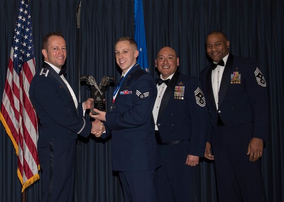 Senior Airman Taylor Clay accepts the 366th Fighter Wing Airman of the Year award from 366th FW Commander Col. David Iverson, (left) 12th Air Force Command Chief Master Sgt. Jose Barraza and (right) 366th FW Command Chief Master Sgt. David Brown, during the Annual Awards Ceremony at Mountain Home AFB, Idaho, Jan. 29, 2016. Clay is a member of the 366th Operations Group at Mountain Home AFB. (U.S. Air Force photo by Senior Airman Jeremy L. Mosier/Released)