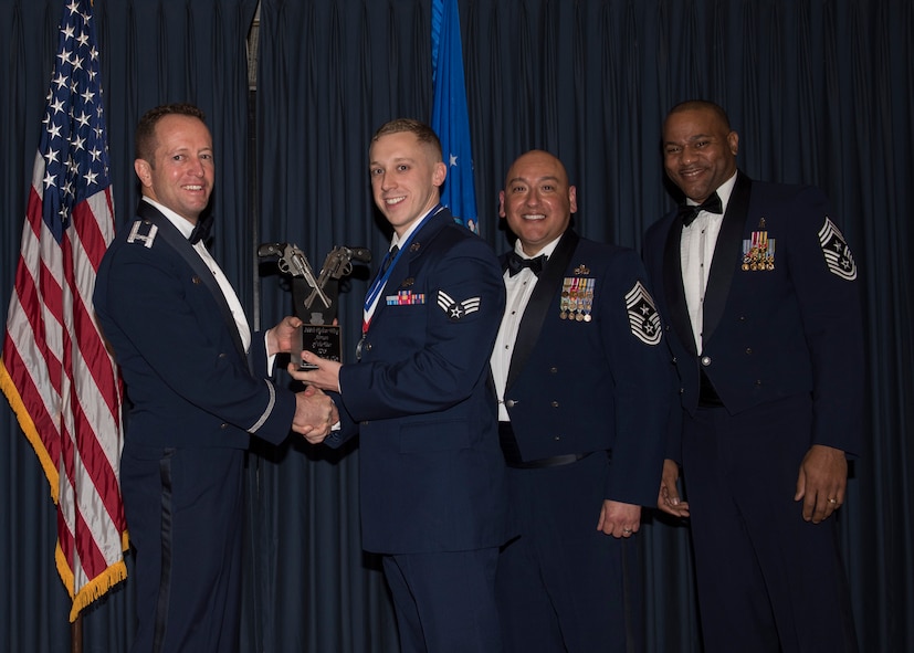 Senior Airman Taylor Clay accepts the 366th Fighter Wing Airman of the Year award from 366th FW Commander Col. David Iverson, (left) 12th Air Force Command Chief Master Sgt. Jose Barraza and (right) 366th FW Command Chief Master Sgt. David Brown, during the Annual Awards Ceremony at Mountain Home AFB, Idaho, Jan. 29, 2016. Clay is a member of the 366th Operations Group at Mountain Home AFB. (U.S. Air Force photo by Senior Airman Jeremy L. Mosier/Released)