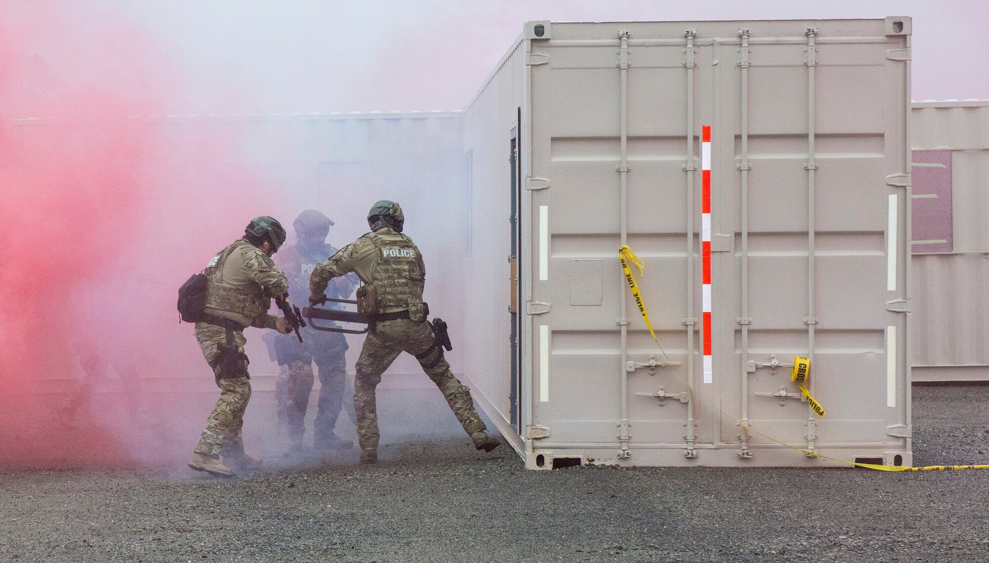 Airmen from the 60th Security Forces Squadron and members of the Vacaville Police Department conduct a joint demonstration of a breach and clearing scenario Jan. 29, 2016, at the newly constructed Emergency Responder Urban Training Site at Travis Air Force Base, California. The overarching goal of the site is to enable emergency responders from Travis as well as local and federal law enforcement agencies to train together and integrate operations. (U.S. Air Force photo by Heide Couch)