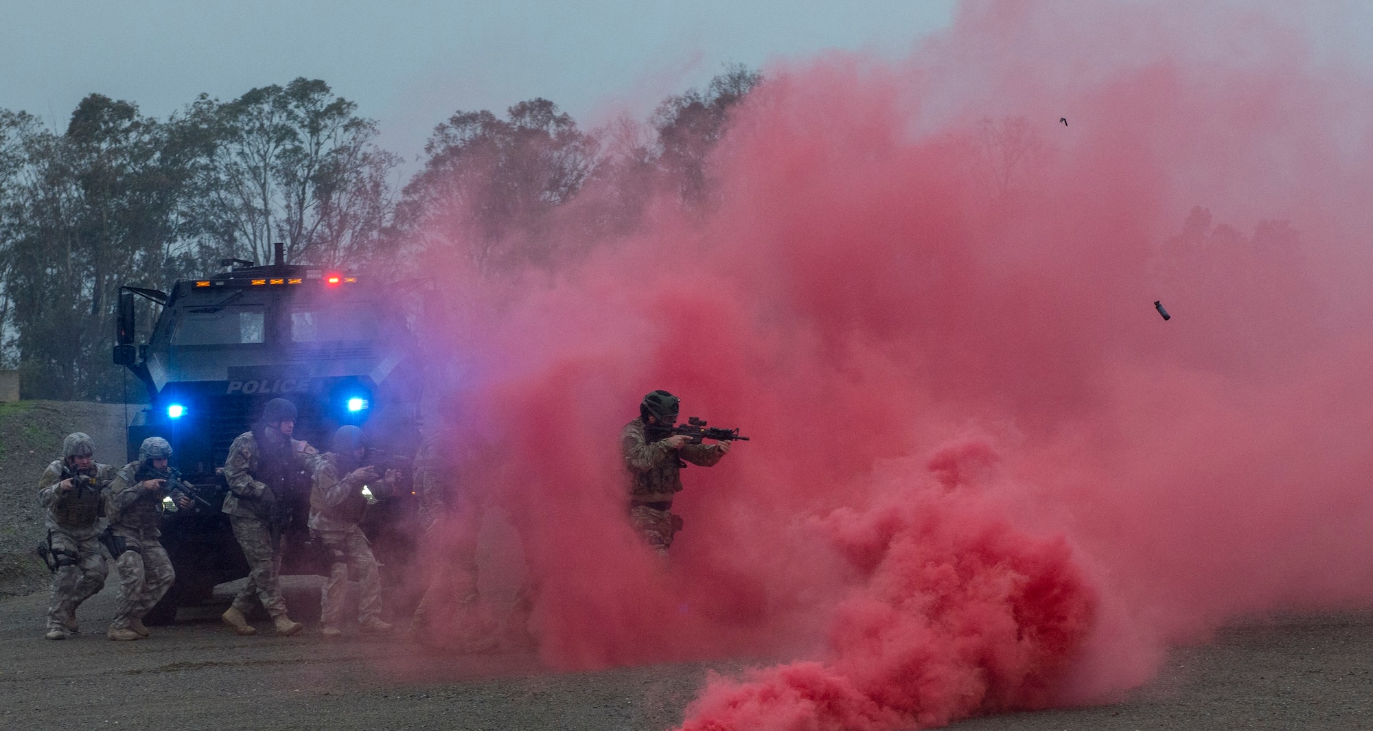 Airmen from the 60th Security Forces Squadron and members of the Vacaville Police Department conduct a joint demonstration of a breach and clearing scenario Jan. 29, 2016, at the newly constructed Emergency Responder Urban Training Site at Travis Air Force Base, California. The overarching goal of the site is to enable emergency responders from Travis as well as local and federal law enforcement agencies to train together and integrate operations. (U.S. Air Force photo by Heide Couch)