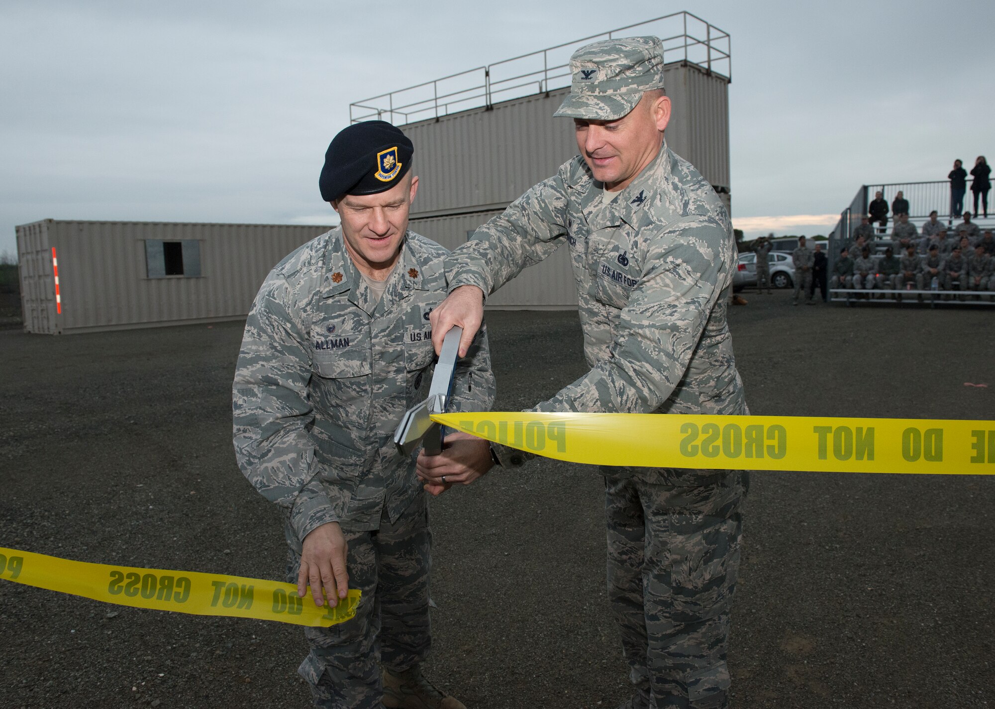 Maj. Jearl Allman, 60th Security Forces Squadron commander, left, and Col. George Dietrich, 60th Mission Support Group commander, right, cut a ribbon Jan. 29, 2016, signifying the official opening of the newly constructed Emergency Responder Urban Training Site at Travis Air Force Base, Calif. The ERUTS is the first tangible project completed at Travis as a direct result of the Air Force Community Partnership program. (U.S. Air Force photo by Heide Couch)