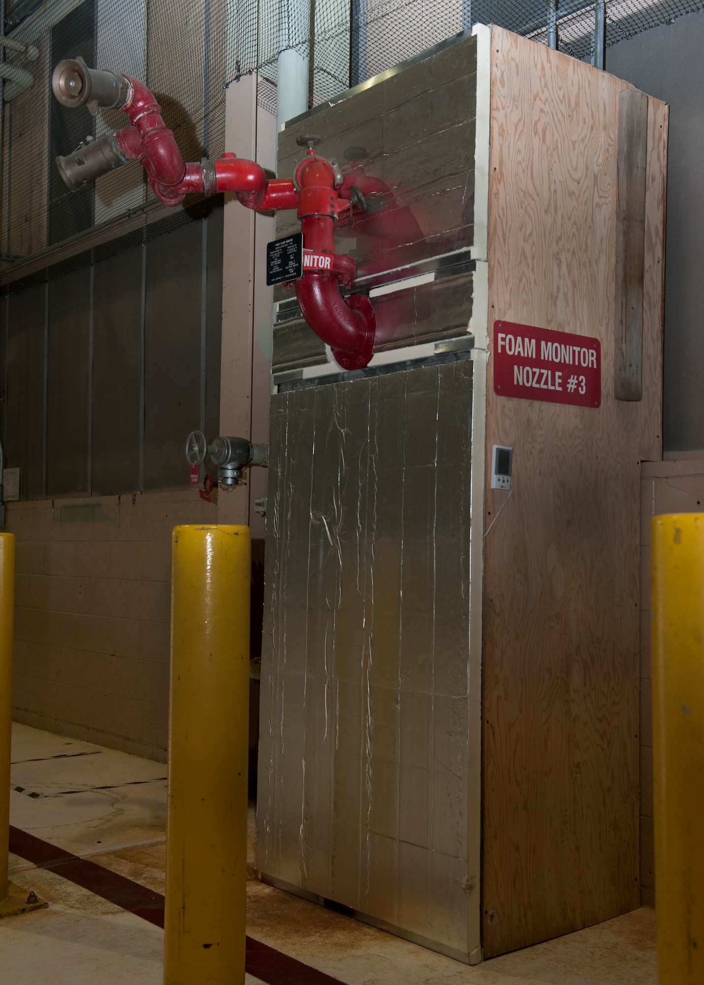A custom built structure sits around a fire suppression system unit Feb. 2, 2016, inside Hangar 715 on Dover Air Force Base, Del. The structure acts to keep cold air away from the unit’s piping to present their freezing. (U.S. Air Force photo/Senior Airman Zachary Cacicia)