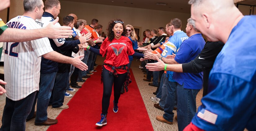 Airman 1st Class Leesel Lewis, 628th Comptroller Squadron financial services technician, runs down the red carpet during the 2015 628th Air Base Wing Annual Awards Ceremony Jan. 29, 2016, at the Charleston Club on JB Charleston – Air Base, S.C. 