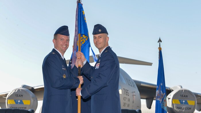 (From left to right) Colonel Scovill Currin, 437th Operations Group commander, passes command of the 437th Operations Support Squadron to Lt. Col. Todd Markwart at Joint Base Charleston – Air Base, S.C., on Feb. 2, 2016. The outgoing 437th OSS commander was Lt. Col. Terry Tyree Jr. (U.S. Air Force photo/ Airman 1st Class Thomas T. Charlton 