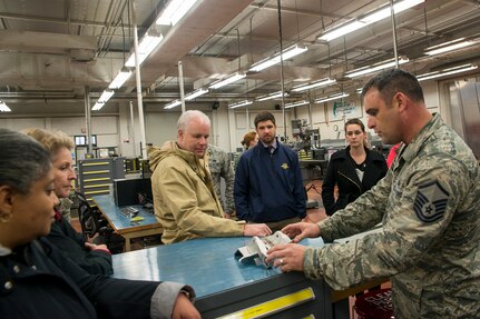 Master Sgt. Timothy Thornton, 437th Maintenance Squadron, metals technology section chief, shows Joint Base Charleston Honorary Commanders an aircraft part that was made by metals technology during a base tour Jan. 22, 2016. The Joint Base Charleston Honorary Commanders Program was developed to encourage an exchange of ideas, experiences and friendship between key members of the local civilian community and the Charleston military community. The program provides a unique opportunity for members of the Charleston area to shadow commanders of wing, group and tenant units at Joint Base Charleston Air Base and Weapons Station. (U.S. Air Force photo/Staff Sgt. William A. O'Brien)