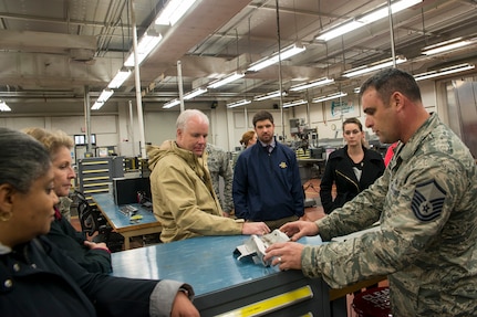 Master Sgt. Timothy Thornton, 437th Maintenance Squadron, metals technology section chief, shows Joint Base Charleston Honorary Commanders an aircraft part that was made by metals technology during a base tour Jan. 22, 2016. The Joint Base Charleston Honorary Commanders Program was developed to encourage an exchange of ideas, experiences and friendship between key members of the local civilian community and the Charleston military community. The program provides a unique opportunity for members of the Charleston area to shadow commanders of wing, group and tenant units at Joint Base Charleston Air Base and Weapons Station. (U.S. Air Force photo/Staff Sgt. William A. O'Brien)