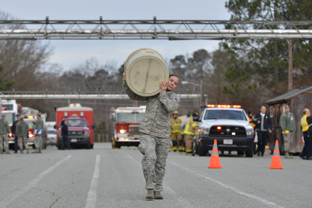 U.S. Air Force Senior Airman Yvonne Maheu, an emergency manager with the 633rd Civil Engineer Squadron, carries materials to a simulated decontamination station at Fort Eustis, Va., Jan. 28, 2016. U.S. Army and Air Force emergency responders worked together to participate and evaluate the chemical, biological, radiological, nuclear and high-yield explosive threat exercise. 