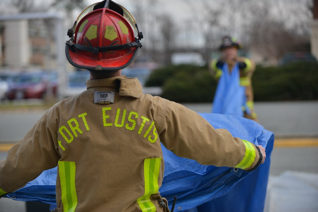 Firefighters build a decontamination station during a joint chemical, biological, radiological, nuclear and high-yield explosive threat exercise at Fort Eustis, Va., Jan. 28, 2016. The firefighters, along with Langley Air Force Base emergency managers, built and managed the decontamination station. (U.S. Air Force photo by Staff Sgt. Natasha Stannard)