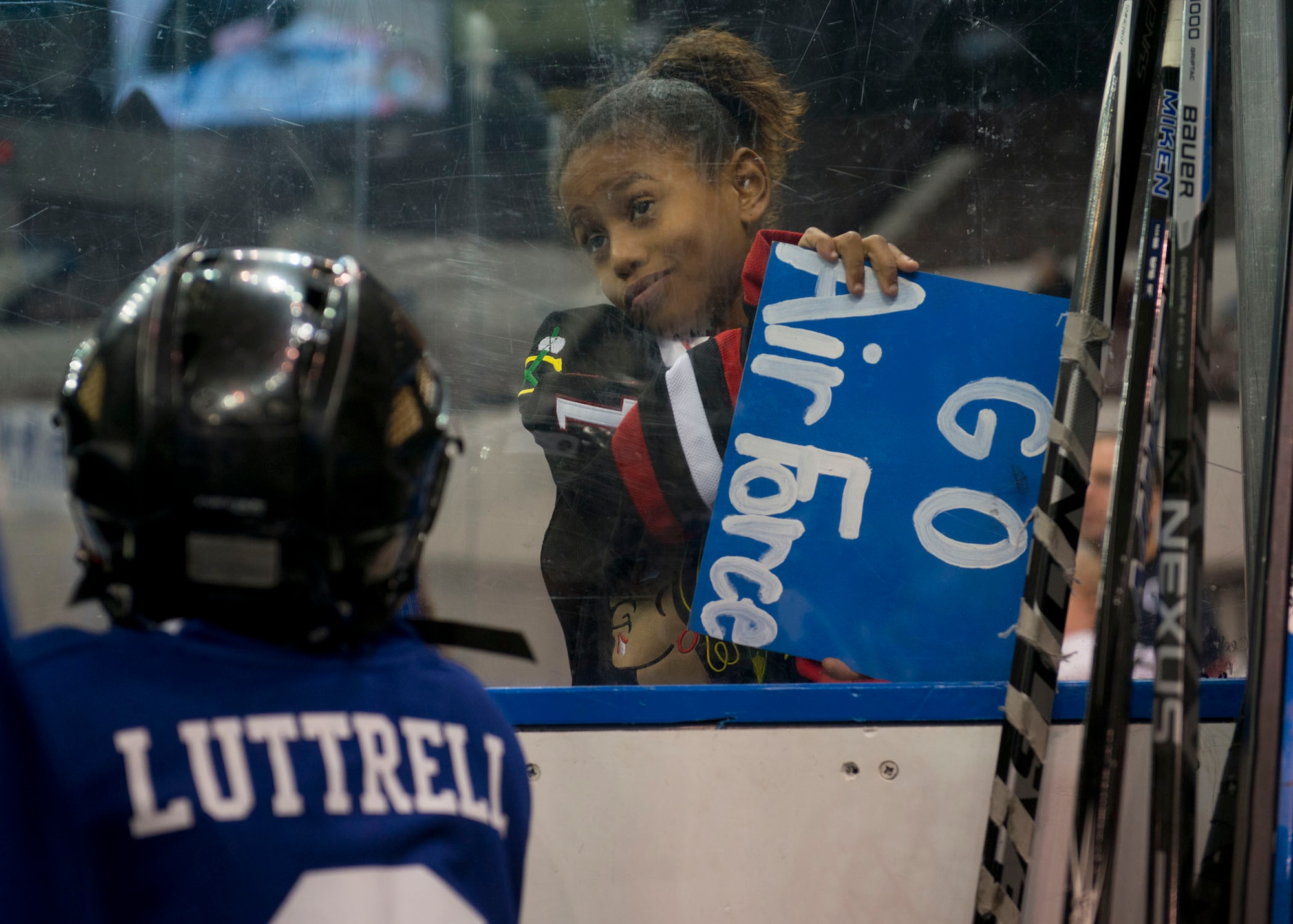 A hockey fan cheers for the Langley Air Force Base Men’s Varsity Hockey team, the Langley Raptors, during the “Air versus Sea” hockey game at the Norfolk Scope Arena in Norfolk, Va., Jan. 30, 2016. The Raptors had a decisive victory, beating the U.S. Navy U.S.S. Abraham Lincoln, 8 to 4. (U.S. Air Force photo by Staff Sgt. J.D. Strong II)