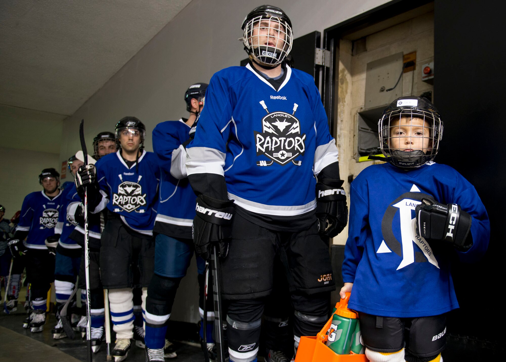 Members of the Langley Air Force Base Men’s Varsity hockey team, the Langley Raptors, wait to take the ice before the “Air versus Sea” hockey game at the Norfolk Scope Arena in Norfolk, Va., Jan. 30, 2016. The Raptors are comprised of members assigned to various units across Langley Air Force Base. (U.S. Air Force photo by Staff Sgt. J.D. Strong II)