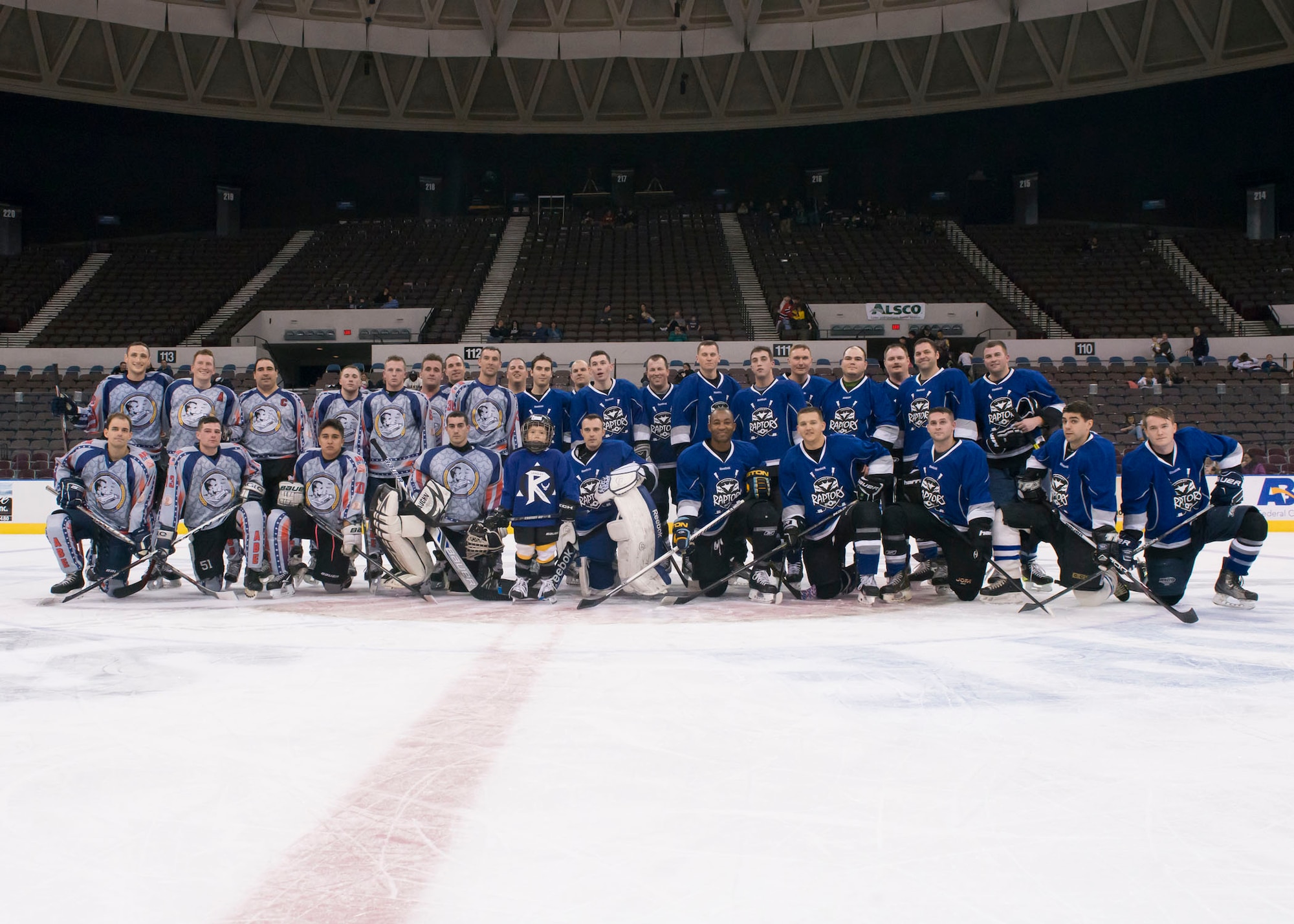 Members of the Langley Air Force Base and U.S. Navy U.S.S. Abraham Lincoln hockey teams’ pose for a group photo after the “Air versus Sea” hockey game at the Norfolk Scope Arena in Norfolk, Va., Jan. 30, 2016. The “Air vs. Sea” game will be played annually. (U.S. Air Force photo by Staff Sgt. J.D. Strong II)