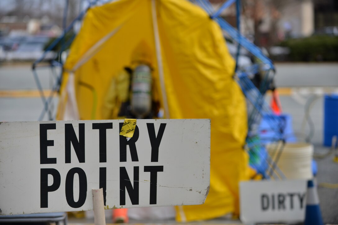 A firefighter enters a decontamination station during a joint chemical, biological, radiological, nuclear and high-yield explosive threat exercise at Fort Eustis, Va., Jan. 28, 2016. Langley Air Force Base emergency managers manned the station and directed the firefighters through the various cleaning areas. (U.S. Air Force photo by Staff Sgt. Natasha Stannard)

