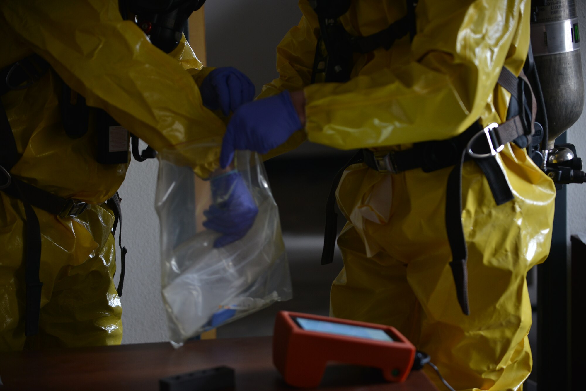 Firefighters collect an envelope containing mock-Anthrax during a joint chemical, biological, radiological, nuclear and high-yield explosive (CBRNE) threat exercise at Fort Eustis, Va., Jan. 28, 2016.  This was the first joint CBRNE exercise incorporating Fort Eustis and Langley Air Force Base emergency responders and safety representatives. (U.S. Air Force photo by Staff Sgt. Natasha Stannard)