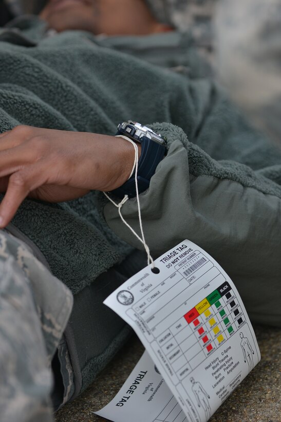 A U.S Airman simulates an injury during a joint chemical, biological, radiological, nuclear and high-yield explosive (CBRNE) threat exercise at Fort Eustis, Va., Jan. 28, 2016. The patients simulated injuries that could occur during CBRNE exposure such as seizures. (U.S. Air Force photo by Staff Sgt. Natasha Stannard)