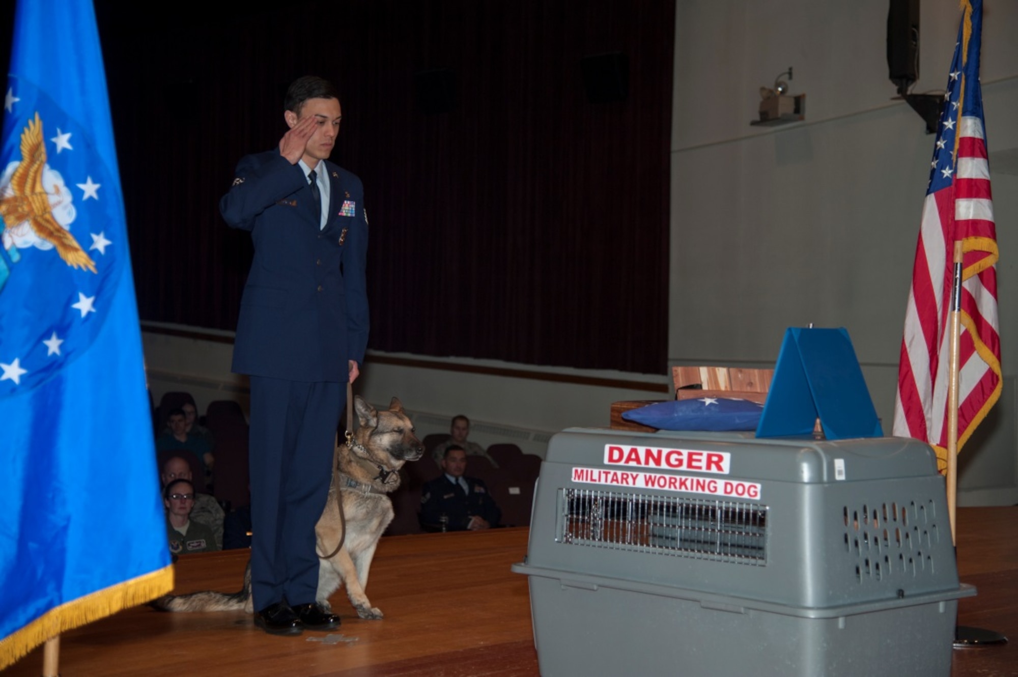 A K9 handler from the 5th Security Forces Squadron pays his respects to Military Working Dog Kitty during her memorial service at Minot Air Force Base, N.D., Feb. 2, 2016. Kitty had been retired for a month when she died of an illness. (U.S. Air Force photo/Airman 1st Class Christian Sullivan)
