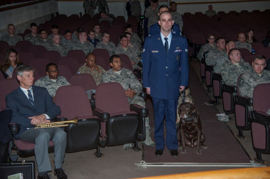 K9 handlers, along with their partners, wait in line to pay their respects to Military Working Dog Kitty at her memorial service at Minot Air Force Base, N.D., Feb. 2, 2016. Kitty had been retired for a month when she died of an illness. (U.S. Air Force photo/Airman 1st Class Christian Sullivan)