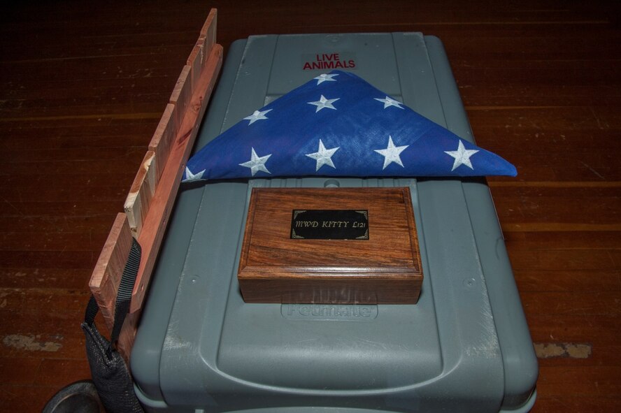 Military Working Dog Kitty’s folded flag and memorabilia sit atop her kennel awaiting her memorial service at Minot Air Force Base, N.D., Feb. 2, 2016. Kitty had been retired for a month when she died of an illness. (U.S. Air Force photo/Airman 1st Class Christian Sullivan)