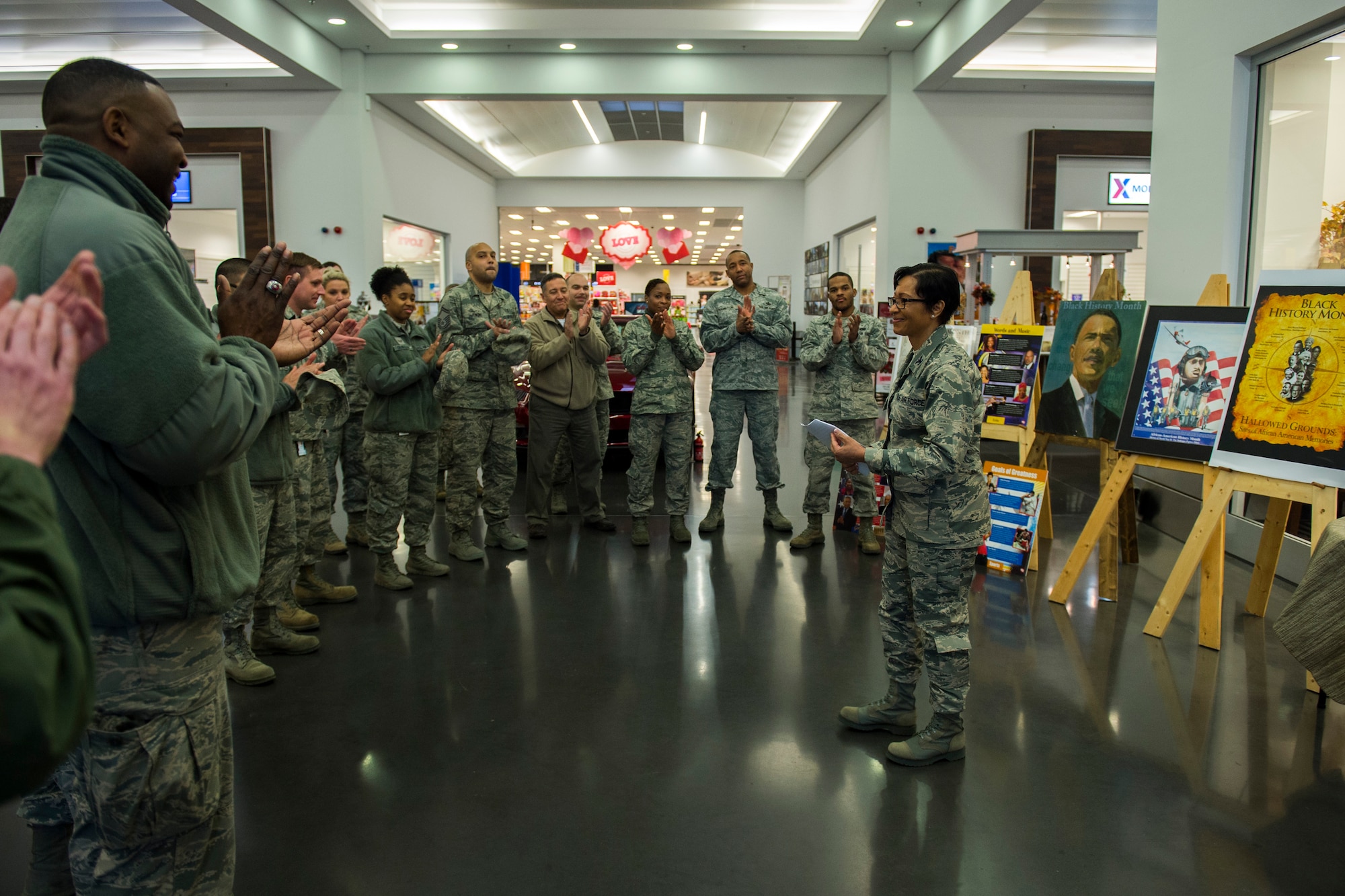 Airmen applause after U.S. Air Force Col. Patricia John, 52nd Medical Operations Squadron commander, gave her opening remarks for National African American History Month at The Exchange on Spangdahlem Air Base, Jan. 2, 2016. This is the 40th consecutive year that February has been NAAHM to remember the efforts and accomplishments of African Americans in the Unites States’ history. (U.S. Air Force photo by Airman 1st Class Luke Kitterman/Released)