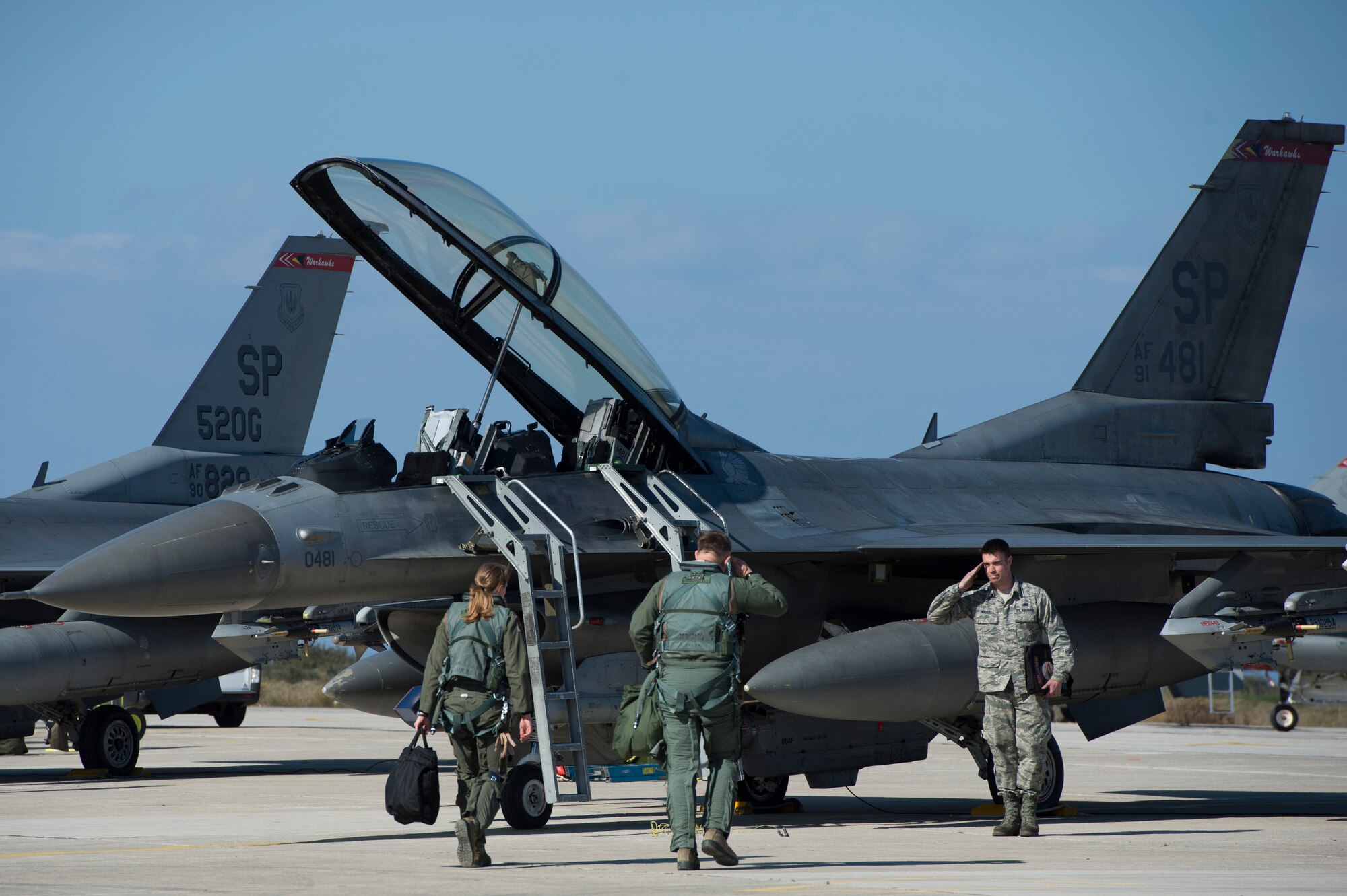 U.S. Air Force Staff Sgt. Daniel Walker, a crew chief assigned to the 480th Expeditionary Fighter Squadron, salutes an F-16 Fighting Falcon fighter aircraft pilot assigned to the 480th EFS and U.S. Air Forces in Europe and Air Forces Africa commander, Gen. Frank Gorenc during a flying training deployment at Souda Bay, Greece, Feb. 1. 2016. Walker, ensured the integrity of the aircraft and helped secure the pilots in the cockpit before departure. (U.S. Air Force photo by Staff Sgt. Christopher Ruano/Released)