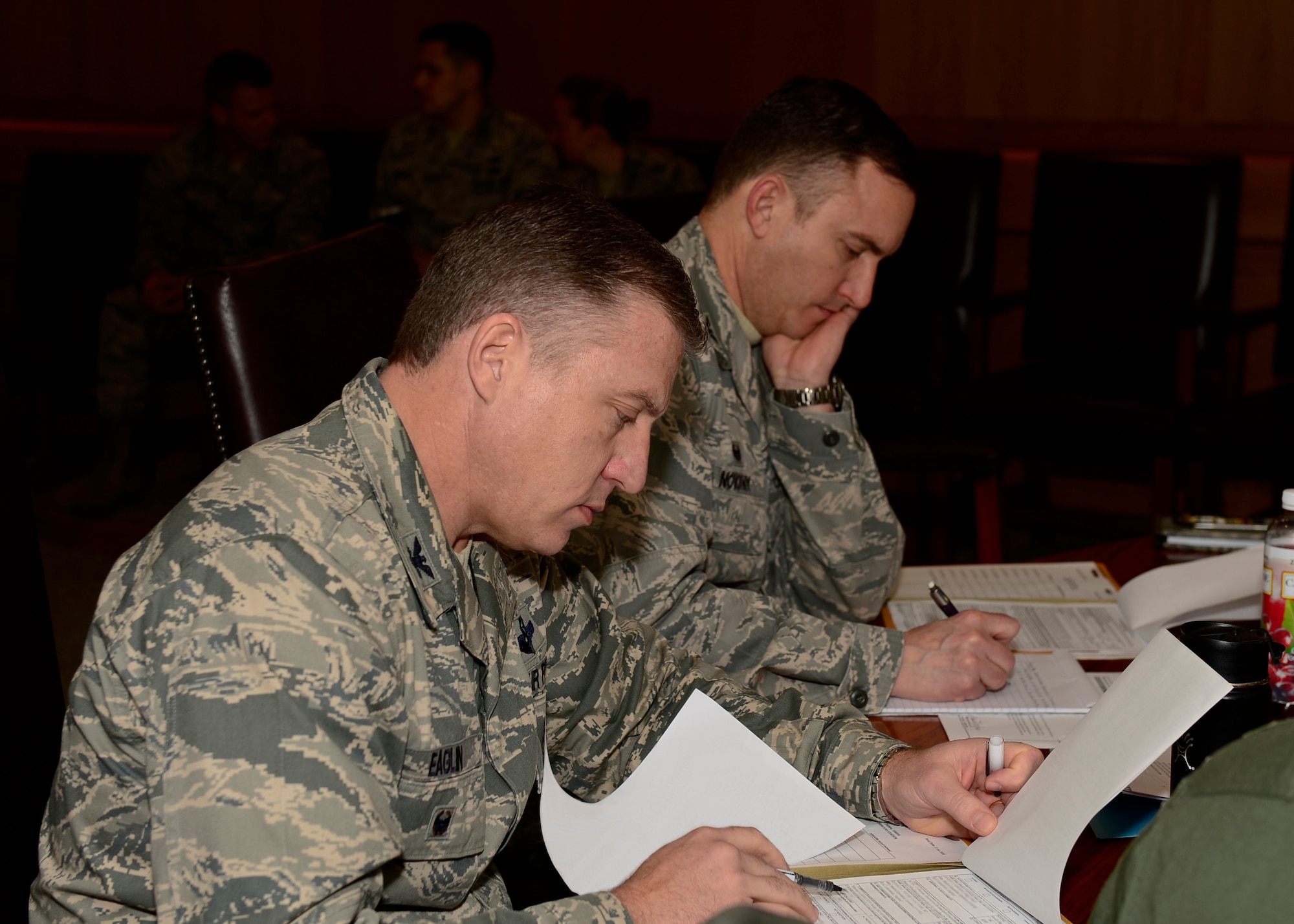 Col. David Eaglin, 48th Fighter Wing vice commander, and Col. Robert Novotny, 48th Fighter Wing commander, review packages during the 48th Fighter Wing’s first-ever Enlisted Forced Distribution Panel at Royal Air Force Lakenheath , England, Jan. 27, 2016. The EFDP, chaired by Col. Robert Novotny, 48th FW commander, is composed of unit commanders with the purpose of determining the most qualified technical sergeants ready for promotion. (U.S. Air Force photo illustration by Senior Airman Nigel Sandridge/ Released)