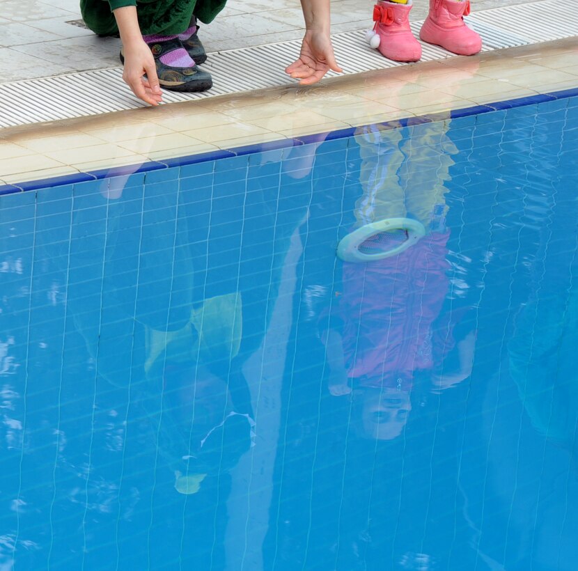 Polar plunge participants test the temperature of the water with their hands before jumping into the base pool Jan. 20, 2016, at Incirlik Air Base, Turkey. The event is sponsored by the 39th Force Support Squadron and challenges people to test their bravery and tolerance to cold water. (U.S. Air Force photo by Airman 1st Class Daniel Lile/Released)