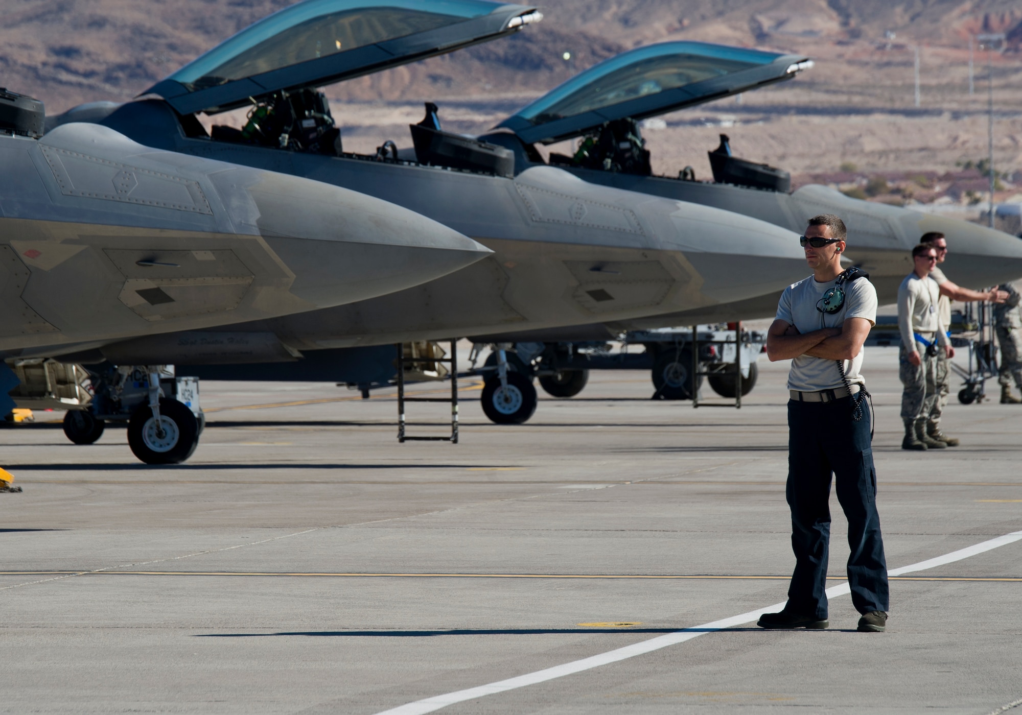 Staff Sgt. Robert Mackle, 95th Aircraft Maintenance Unit crew chief from Tyndall AFB, Fla., waits on the F-22 Raptor pilots to arrive during Red Flag 16-1, Jan. 28, 2016 at Nellis AFB, Nev. Hundreds of maintainers from around the world ensure the mission is executed safely and efficiently during the exercise. (U.S. Air Force photo by Senior Airman Alex Fox Echols III/Released)
