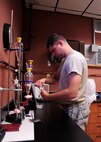 Senior Airman David Bryant, 325th Logistics Readiness Squadron NCO in charge of fuels laboratory, preps materials for a fuels test Jan. 29, 2016, at the fuels laboratory. These assessments are performed to test fuel for its water content, solids content, and additives in the fuel such as corrosion inhibitor and static dissipating additive. (U.S. Air Force photo Senior Airman Solomon Cook/Released)