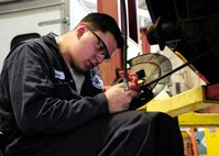 Staff Sgt. Christian Chavez, 325th Logistics Readiness Squadron vehicle maintenance supervisor, replaces an emergency brake cable on a government owned vehicle Feb. 2 at the vehicle maintenance shop. From trucks to buses, technicians like Chavez must have an extensive knowledge of the vehicles that come through the shop. (U.S. Air Force photo by Senior Airman Solomon Cook/Released)

