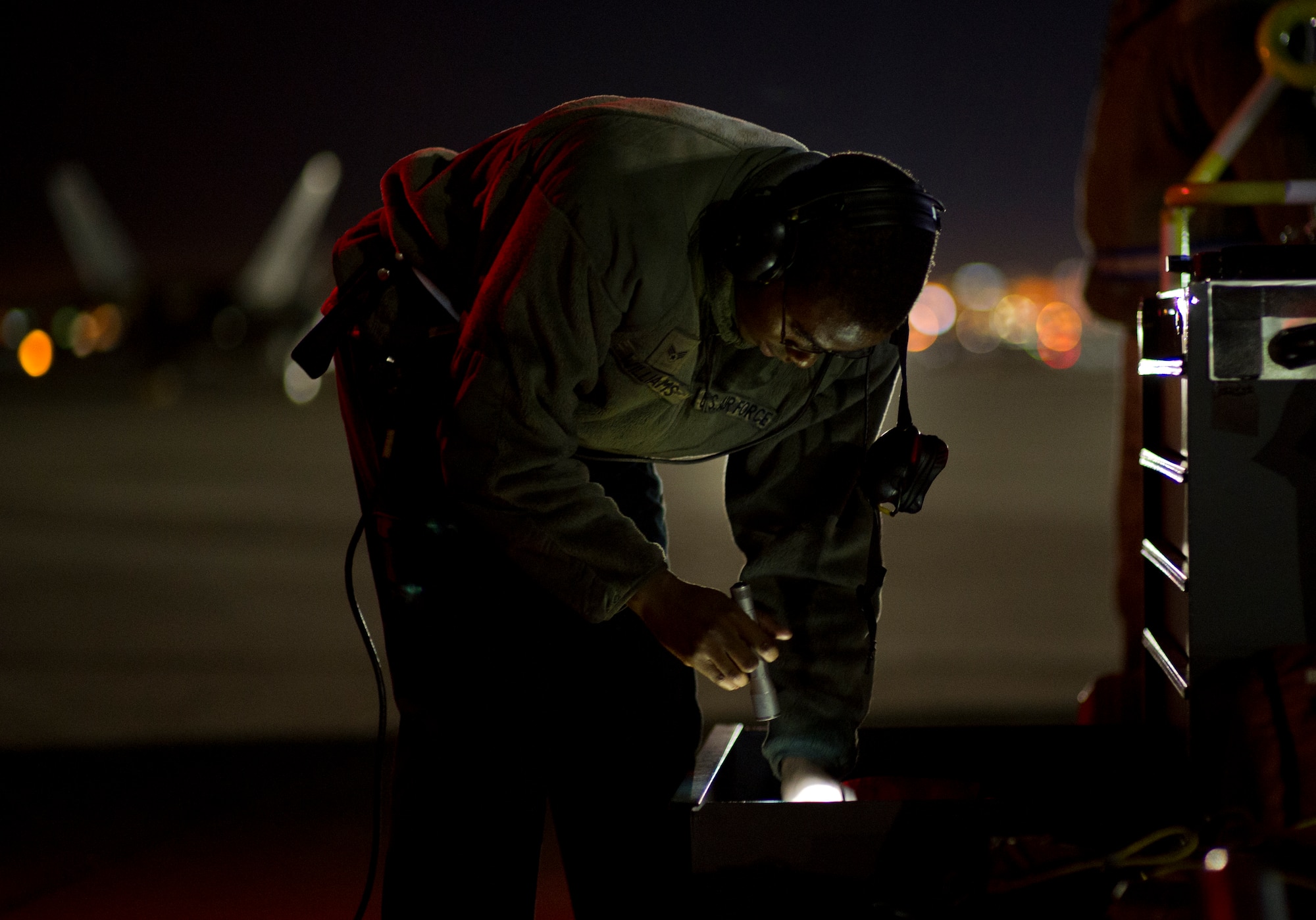 Senior Airman Nigel Williams, 95th Aircraft Maintenance Unit crew chief, searches for something in his toolbox, Jan. 26 at Nellis AFB, Nev. Airmen are honing their skills with three weeks of exercise training alongside squadrons from around the world. (U.S. Air Force photo by Senior Airman Alex Fox Echols III/Released)  