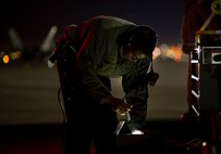Senior Airman Nigel Williams, 95th Aircraft Maintenance Unit crew chief, searches for something in his toolbox, Jan. 26 at Nellis AFB, Nev. Airmen are honing their skills with three weeks of exercise training alongside squadrons from around the world. (U.S. Air Force photo by Senior Airman Alex Fox Echols III/Released)  