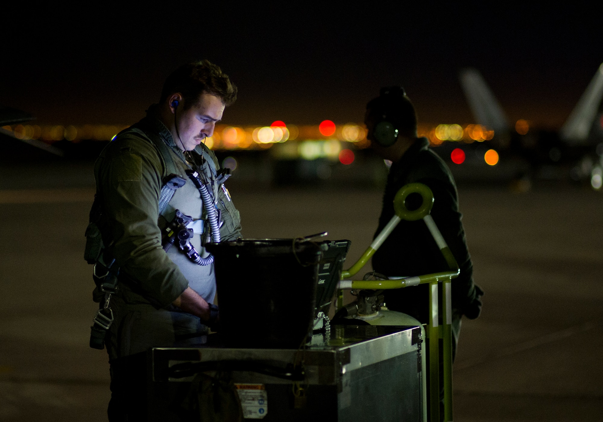 First Lt. Douglas Foss, 95th Fighter Squadron F-22 Raptor pilot, goes through pre-flight procedures during Red Flag 16-1, Jan. 26 at Nellis AFB, Nev. More than 30 squadrons at Red Flag 16-1 are working together as they would in the field, possibly for the first time, before facing an actual threat. (U.S. Air Force photo by Senior Airman Alex Fox Echols III/Released)   