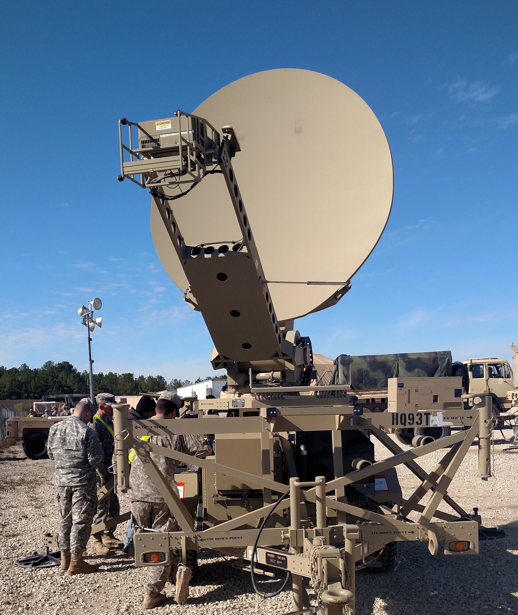 FORT POLK, La. -  Sgt. Brett Smith and Spc. Barry Fletcher, Company A, 53rd Signal Battalion satellite controllers, assist 1st Stryker Brigade Combat Team tactical operators with power balancing procedures during a training rotation at the Joint Readiness Training Center here Jan. 5-17.