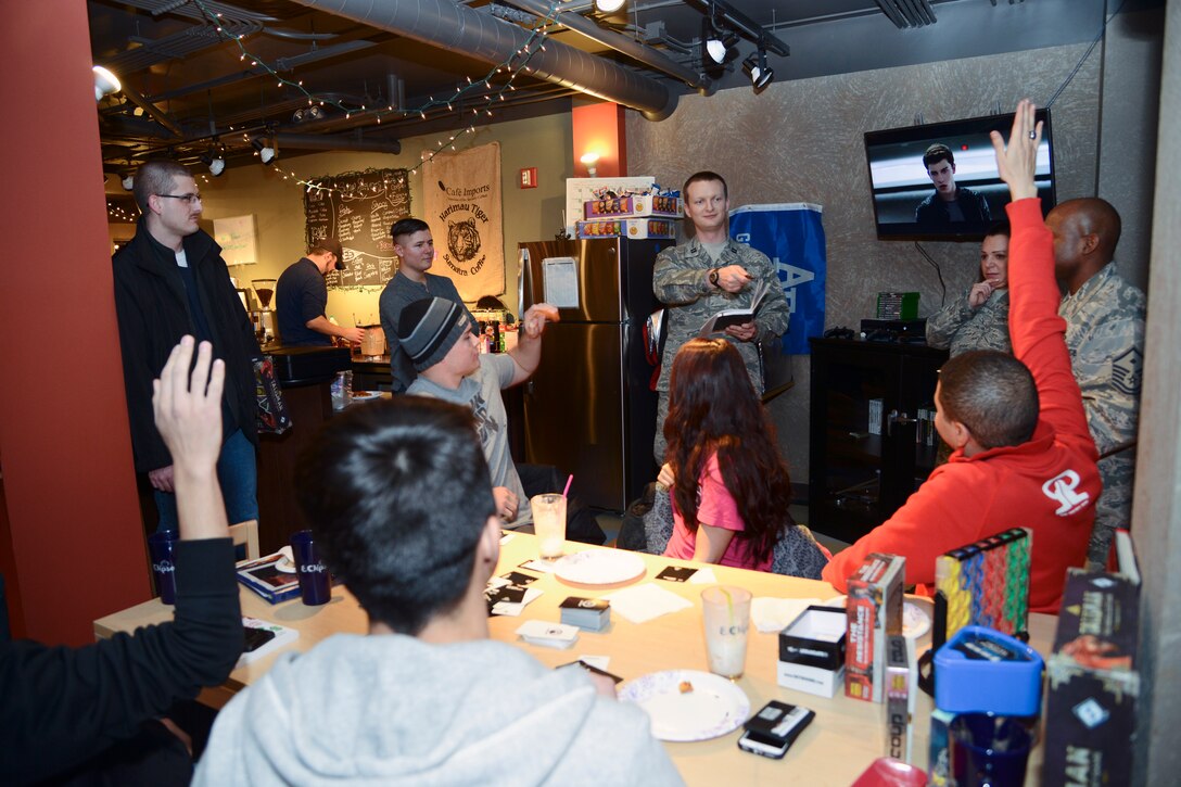 PETERSON AIR FORCE BASE, Colo. – Chaplain (Capt.) Portmann Werner, 50th Space Wing Chapel, asks questions during Star Wars trivia during the grand re-opening of the Eclipse Cyber Café on Jan. 27, 2016. To highlight the benefits of the café for Airmen in the dorms, the Chapel sponsored the event featuring food, games and fun. Airmen from the dorms, as well as 21st Space Wing leadership joined the chapel to rechristen the café. (U.S. Air Force photo by Tech. Sgt. Jared Marquis)