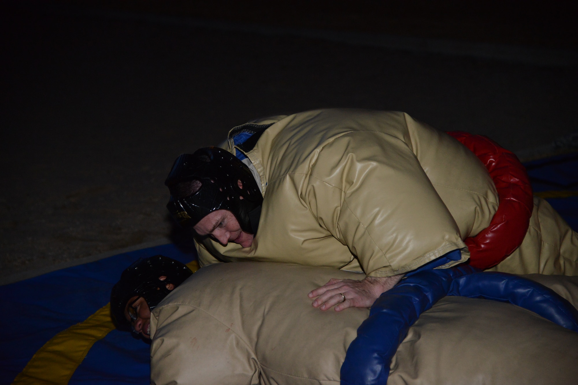 PETERSON AIR FORCE BASE, Colo. – Col. Eric Dorminey, 21st Space Wing vice commander, pins  Airman 1st Class Hersey Mayo, 21st Aerospace Medicine Squadron, during sumo wrestling at the grand re-opening of the Eclipse Cyber Café on Jan. 27, 2016. To highlight the benefits of the café for Airmen in the dorms, the Chapel sponsored the event featuring food, games and fun. Airmen from the dorms, as well as 21st Space Wing leadership joined the chapel to rechristen the café. (U.S. Air Force photo by Tech. Sgt. Jared Marquis)