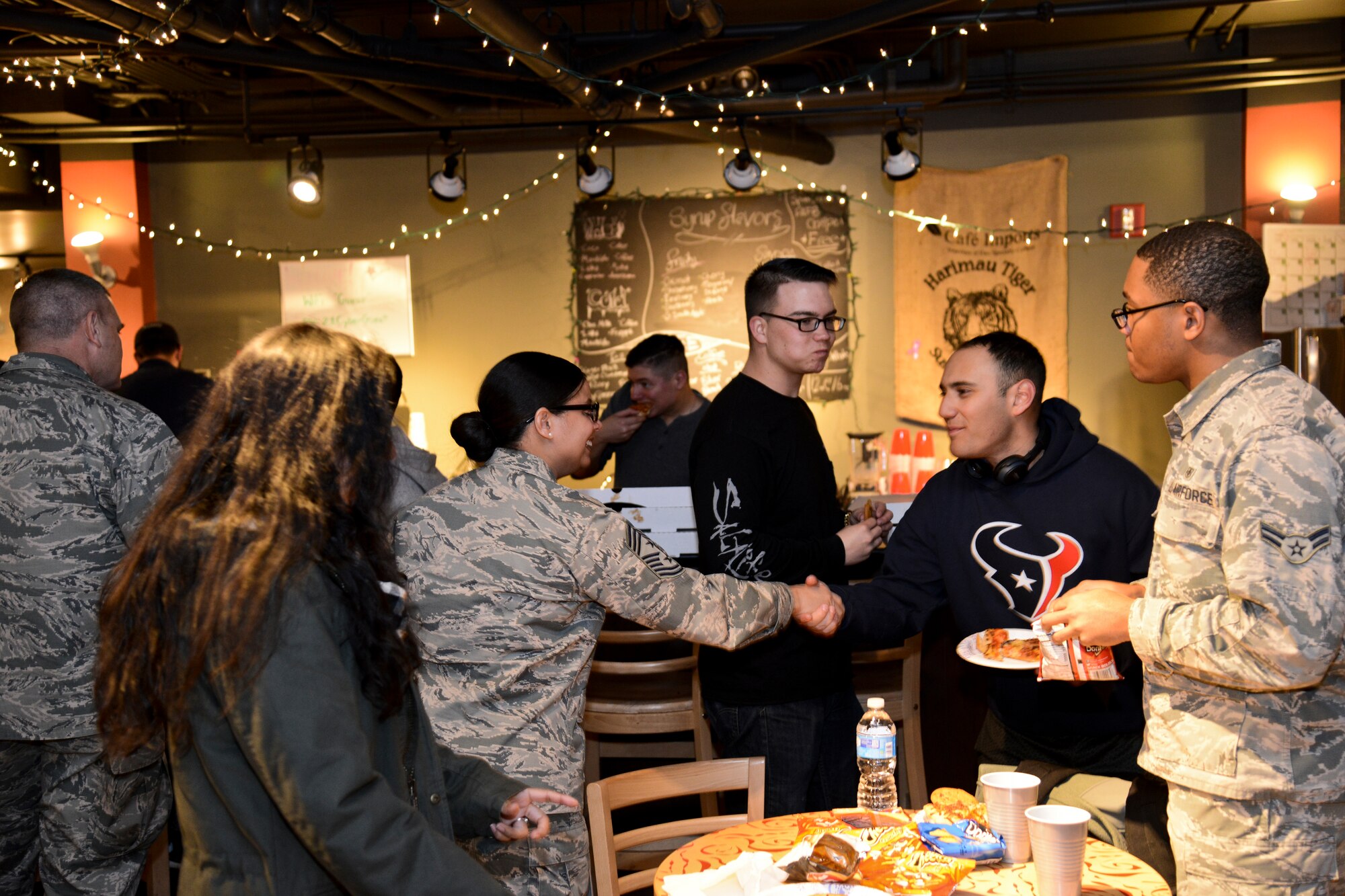 PETERSON AIR FORCE BASE, Colo. – Chief Master Sgt. Idalia Peele, 21st Space Wing command chief, greets Airmen at the Eclipse Cyber Café on Jan. 27, 2016. To highlight the benefits of the café for Airmen in the dorms, the Chapel sponsored a grand re-opening ceremony featuring food, games and fun. Airmen from the dorms, as well as 21st Space Wing leadership joined the chapel to rechristen the café. (U.S. Air Force photo by Tech. Sgt. Jared Marquis)