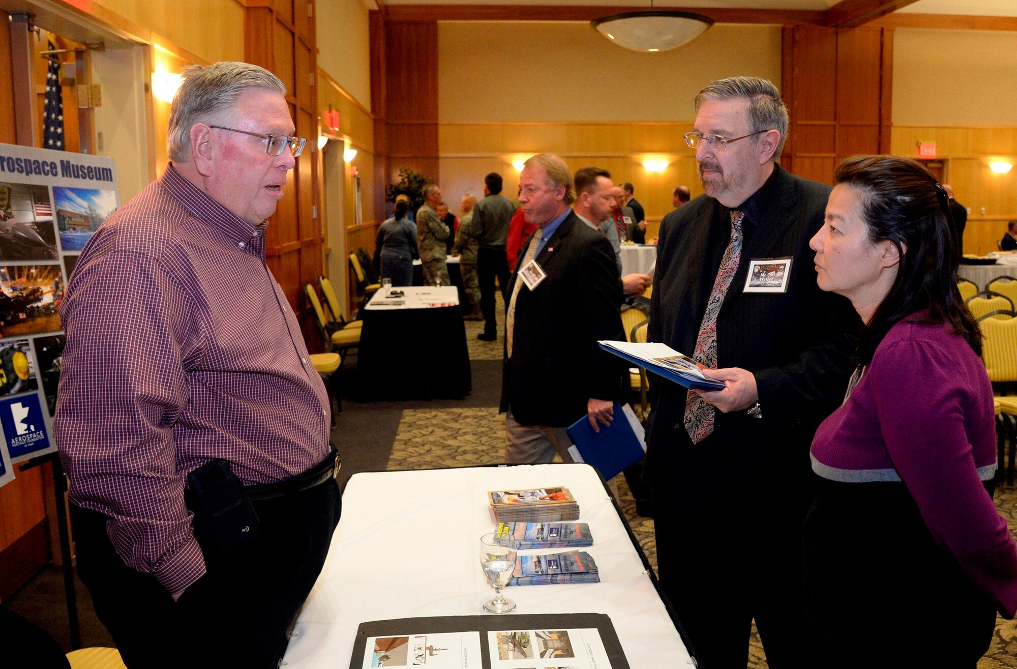 (Left to right) Robb Alexander, Aerospace Heritage Foundation of Utah, shares information with honorary Curt Watson, Family Counseling Services of Northern Utah, and Dr. Yoon Hamrick, 309th Maintenance Support Group director, following the Honorary Commander Induction Ceremony at Hill Air Force Base Feb. 2. After the induction ceremony, honorary commanders and their guests were treated to a base information fair. (U.S. Air Force photo by Todd Cromar)