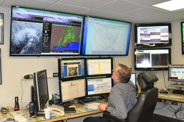 James Lane, the senior operational forecaster in the Wright-Patterson Air Force Base Weather Station, observes various screens to monitor and predict coming storms.  (U.S. Air Force photo/Gina Marie Giardina)