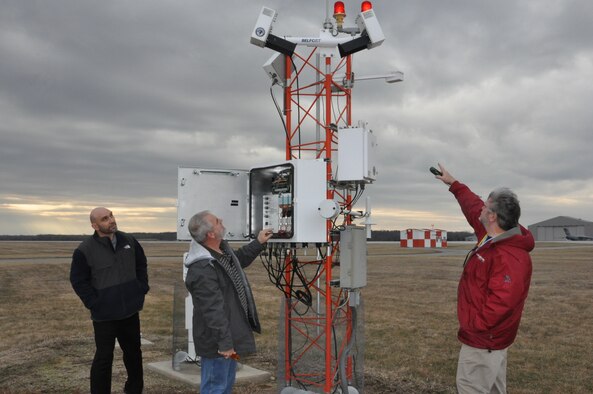 (from left) Meteorologist Scott Lutz, Electronics Technician Marvin Mullins and Forecaster Brent Sullins, all personnel in 88 OSS who keep the Weather Station up and running, discuss the capabilities of the FMQ19, an automated weather observing system located on the base flight line.  (U.S. Air Force photo/Gina Marie Giardina)