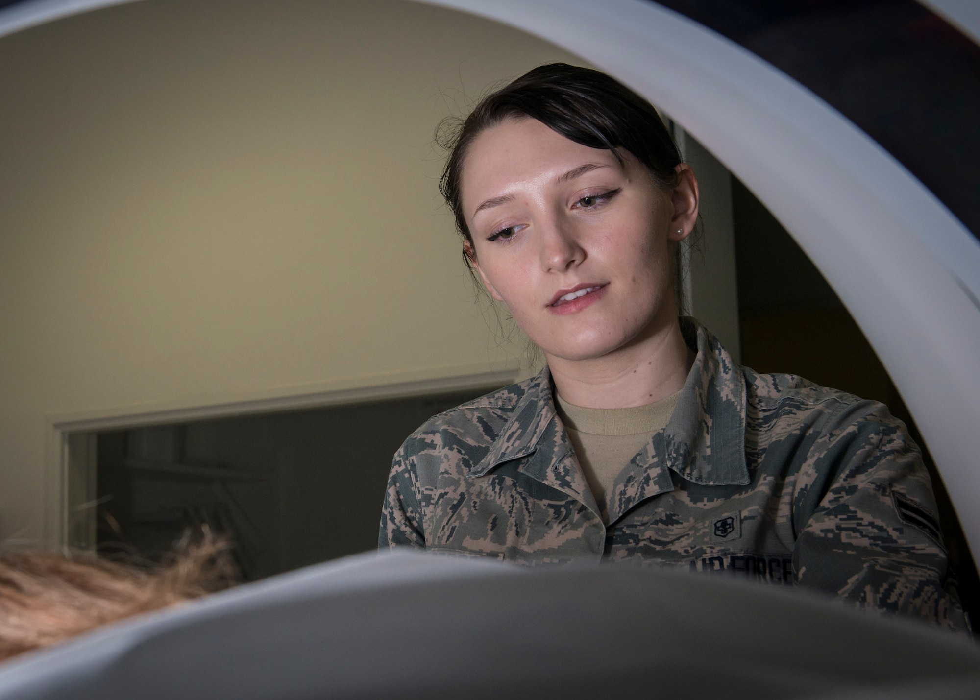 U.S. Air Force Airman 1st Class Samantha Bradford, a diagnostic imaging technologist with the 35th Surgical Operations Squadron, chats with a kidney stone patient as she conducts a computerized tomography scan at Misawa Air Base, Japan, Jan. 27, 2016. Talking with the patient during CT scans alleviates apprehension commonly associated with the procedure. Bradford is a Corinth, Maine, native. (U.S. Air Force photo by Staff Sgt. Benjamin W. Stratton)