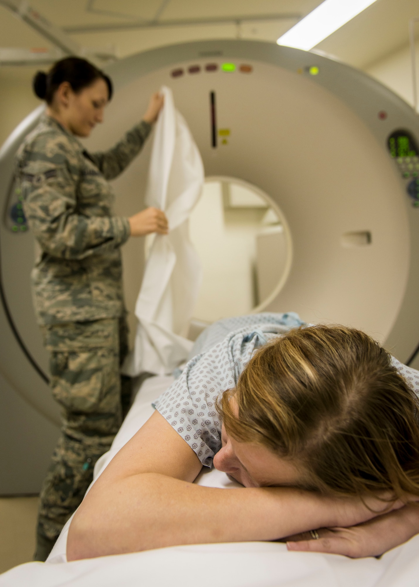 U.S. Air Force Airman 1st Class Samantha Bradford, a diagnostic imaging technologist with the 35th Surgical Operations Squadron, covers a kidney stone patient as she prepares her for a computerized tomography scan at Misawa Air Base, Japan, Jan. 27, 2016. The CT scan will provide a 3-D view of the patient’s bones and internal organs including her urinary system. The high resolution scan allows Bradford to see the stones and their exact locations so the physicians know precisely where to create an incision for extraction. Bradford is a Corinth, Maine, native. (U.S. Air Force photo by Staff Sgt. Benjamin W. Stratton)