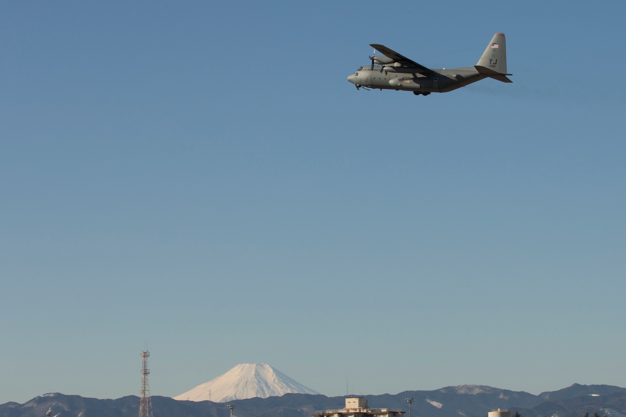 A C-130 Hercules from the 36th Airlift Squadron flies over Yokota Air Base, Japan, Jan. 25, 2016. The 36 AS regularly conducts training missions to remain proficient in the necessary skills to support any contingency. (U.S. Air Force photo by Osakabe Yasuo/Released) 