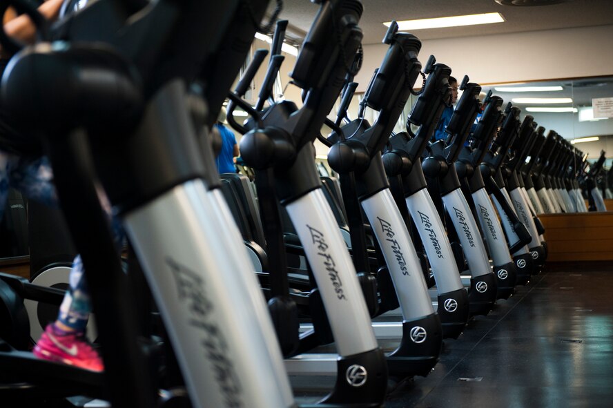 Risner Fitness Center patrons use the new elliptical machines, Feb. 3, 2016, at Kadena Air Base, Japan. The 16 new machines are just a small part of the equipment refresh, which also included 40 spin bikes, 19 treadmills, one arm ergometer, 11 recumbent cycles, 12 upright cycles, and eight stairclimbers. (U.S. Air Force photo by Airman Zackary A. Henry)