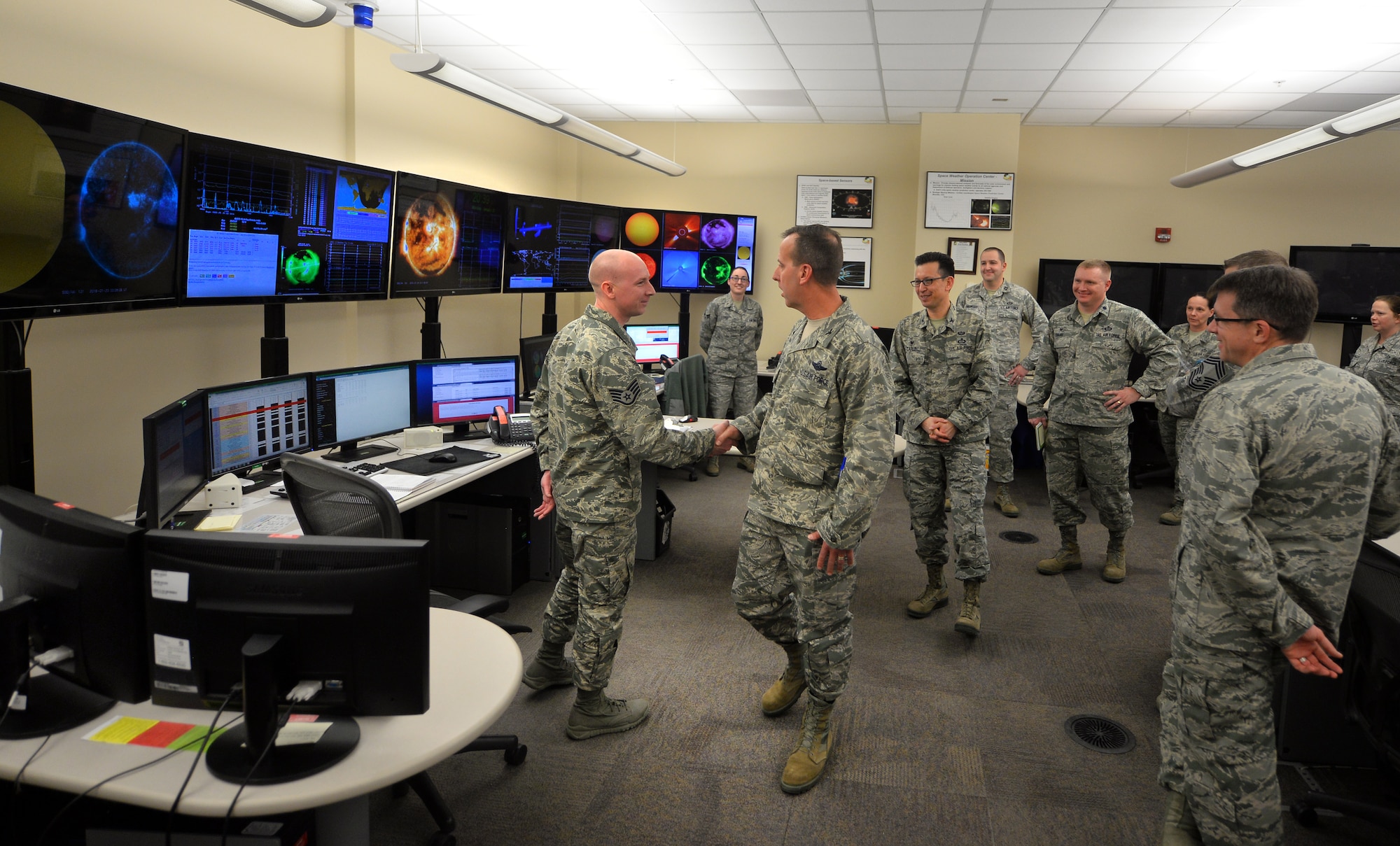 U.S. Air Force Col. Jay R. Bickley, 12th Air Force (Air Forces Southern)  vice commander, greets Airmen as he tours the Space Weather Operations Center during his tour of the 557th Weather Wing, Offutt Air Force Base, Neb., Jan. 25, 2016.  Bickley spent the day meeting Airmen and learning about their daily operations.  (U.S. Air Force photo by Josh Plueger/released)