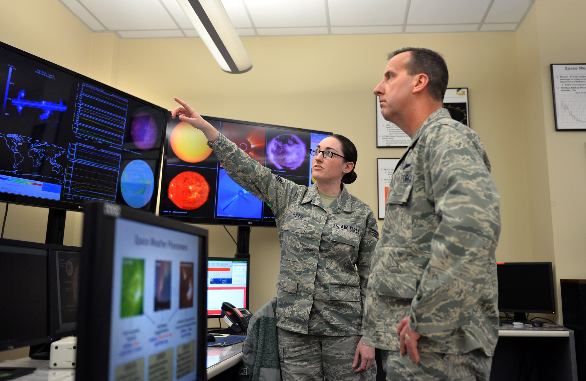 U.S. Air Force Senior Airman Amanda Otto, assigned to the 2nd Weather Squadron, discusses space weather with U.S. Air Force Col. Jay R. Bickley, 12th Air Force (Air Forces Southern) vice commander, as part of his tour of the 557th Weather Wing, Offutt Air Force Base, Neb., Jan. 25, 2016.  Bickley spent the day meeting  Airmen and learning about their daily operations.  (U.S. Air Force photo by Josh Plueger/released)