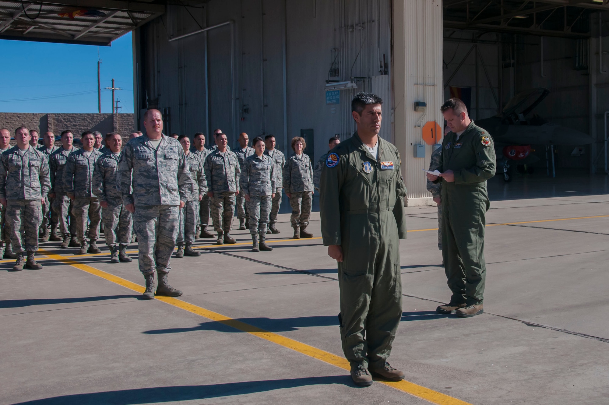 Maj. Douglas Charters director of operations of the Arizona Air National Guard’s 162nd Wing Aerospace Control Alert detachment located at Davis-Monthan Air Force Base reads the Air Force Outstanding Unit Award citation during a presentation ceremony.  The AFOUA was given to the ACA for outstanding performance during the period of Nov. 1, 2012 through Oct. 31, 2014. (U.S. Air National Guard photo by 2d Lt. Lacey Roberts)