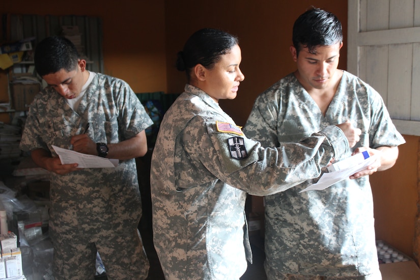 Service members from Joint Task Force-Bravo Medical Element assigned to pharmacy duties, read prescriptions before dispatching to the local population during a Medical Readiness Training Exercise in Nueva Jerusalén, Gracias a Dios Department, Honduras, Jan. 28, 2016. This is the final station that patients visit after receiving a basic health class, going through a screening process, and after seeing a medical provider. (U.S. Army photo by Maria Pinel/Released)