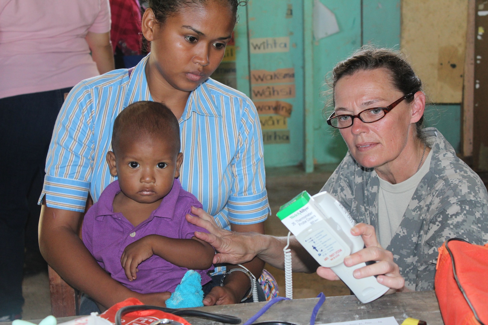 U.S. Army Capt. Penny Wood, a service member with Joint Task Force-Bravo’s Medical Element, checks a child’s temperature during a Medical Readiness Training Exercise in Nueva Jerusalén, Gracias a Dios Department, Honduras, Jan. 28, 2016. For many mothers, these medical exercises between the U.S. and Honduras are the only opportunity for their children to receive medical attention since health care is limited in the remote region. (U.S. Army photo by Maria Pinel/Released)