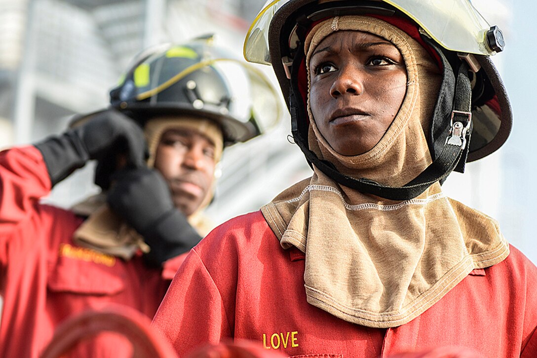 Navy Petty Officer 1st Class Biunca Love prepares to help lead a shipboard aircraft firefighting training event at the firefighting training facility at Naval Station Mayport, Fla., Feb. 2, 2016.  The facility trains sailors attached to ships and components based in Mayport on hose handling, communication procedures and the responsibilities of each member of a hose team. Navy photo by Petty Officer 2nd Class Timothy Schumaker