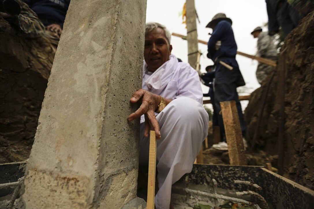 Samai Tanapai Bul plants a wooden stake next to a pillar as part of a Pillar Raising Ceremony, during exercise Cobra Gold 2016 in Waut Ban Mak, Saraburi, Thailand, Jan. 25, 2016.  Cobra Gold 2016, in its 35th iteration, includes a specific focus on humanitarian civic action, community engagement, and medical activities conducted during the exercise to support the needs and humanitarian interests of civilian populations around the region.